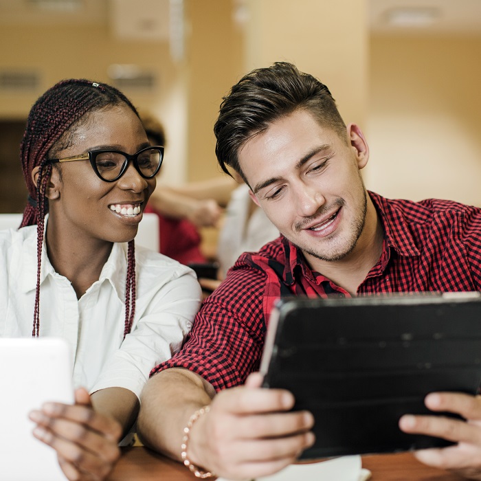 People watching tablet and smiling